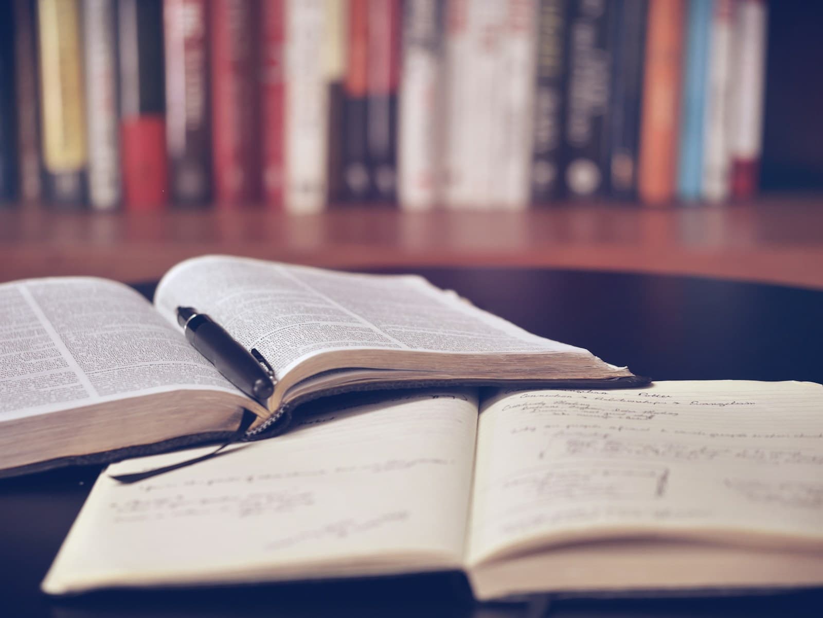 Stack of books on a wooden shelf