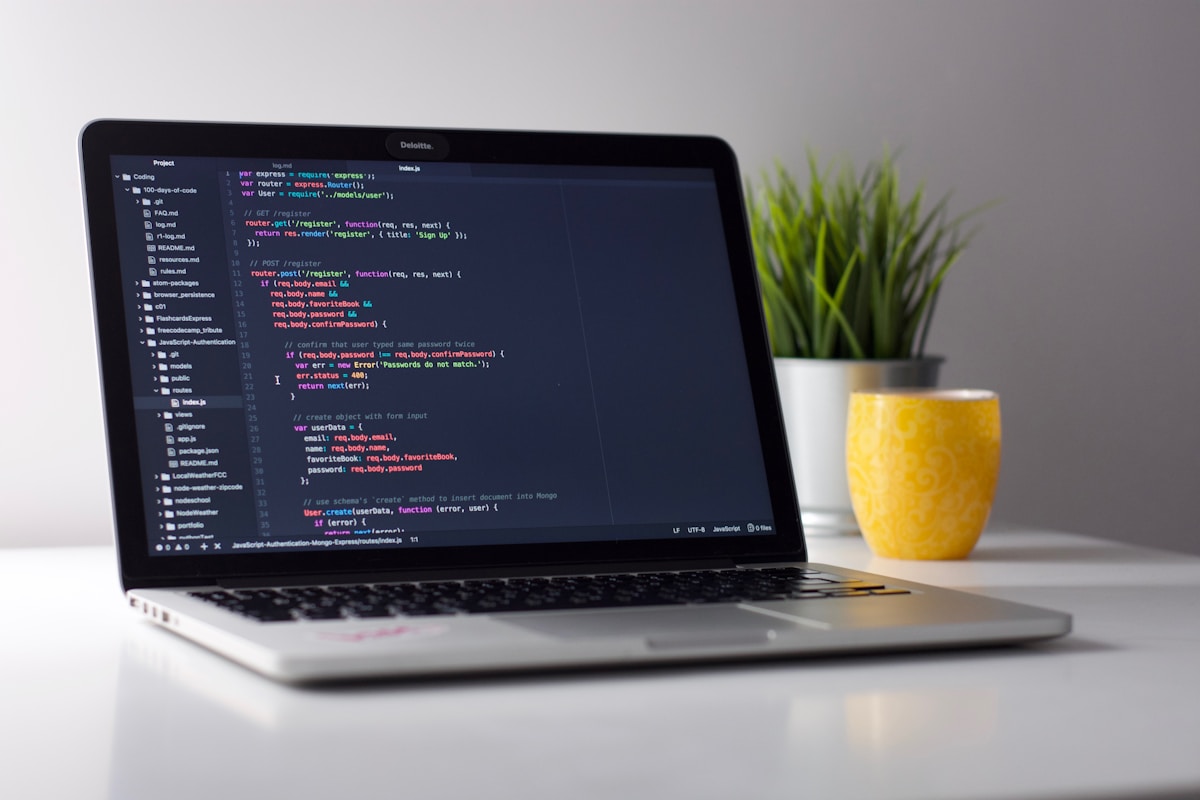 Laptop on a desk showing code in an editor